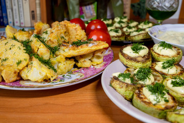 homemade cauliflower in batter and zucchini with tartar sauce and tomatoes
