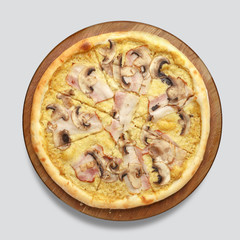 Appetizing pizza on a wooden board isolated on a gray background. Top view.