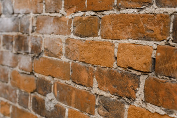 Vertical orange ragged brick wall. Old red brick wall backgrounds. Close up