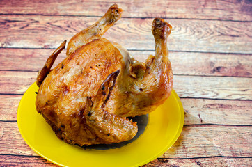 fried chicken on a wooden table in a yellow dish