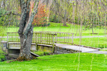 Fototapeta na wymiar Blacksburg historic Virginia Tech Polytechnic Institute and State University College campus with tree and bridge in green garden park