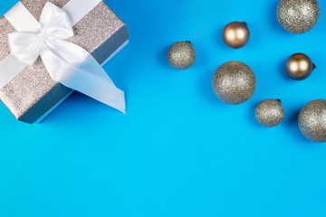 Christmas balls with a gift on a blue background