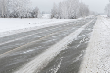 Obraz premium The wind blows off the snow along the highway.