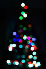 Obraz na płótnie Canvas Christmas tree in defocus. The bokeh is round, in the form of a Christmas tree. Christmas garland out of focus.