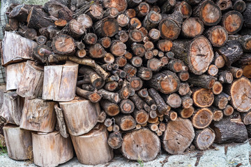 Pile of firewood. Preparation of firewood for winter. 