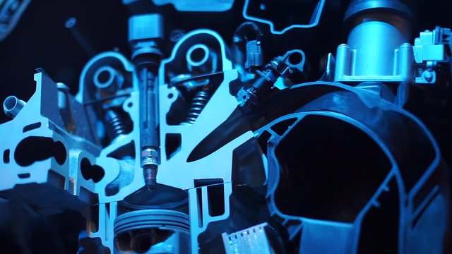 A closeup of a cutaway internal combustion engine.