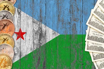 Djibouti savings concept. Bitcoins and dollar banknotes on the side of national flag with wooden background. Trading currencies.