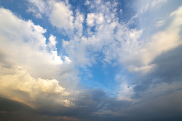 Fototapeta na wymiar Blue sky covered with white puffy clouds.