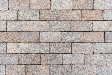 Texture of gray road granite tiles. Stone background. Modern paving slabs. Motley pattern.