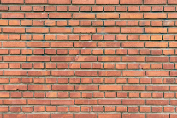 Wall texture of modern brown rough brick. Cross brickwork. Grunge surface background. Vintage orange brickwall.