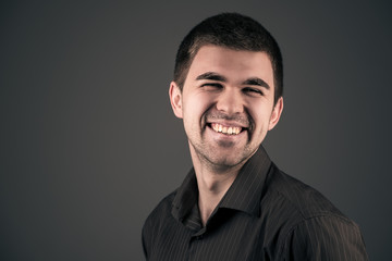 Obraz premium Smiling young handsome emotional man