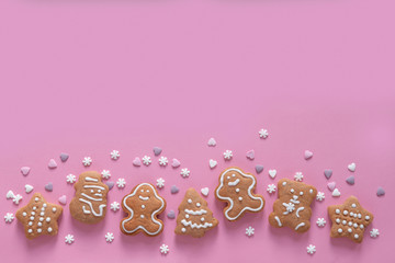 Xmas gingerbread cookies on pastel pink background