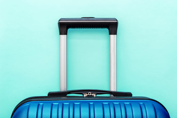 Modern Phantom Blue classic blue suitcase on blue background close up with copy space for text....