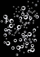 Many googly eyes on black backdrop, top view