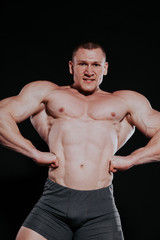 Fototapeta na wymiar Sport the athlete bodybuilder shows off his muscles