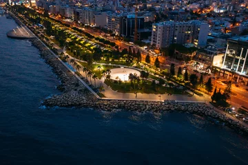 Papier Peint photo Lavable Chypre Aerial night panorama of Limassol, Cyprus waterfront. Famous mediterranean city resort in evening with Molos Park, promenade or embankment and buildings, from above view.