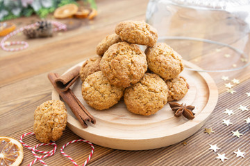 Stack of homemade oatmeal cookies. Christmas healthy cookies, biscuits. Rustic wooden table. Winter decoration.