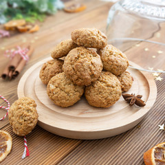 Stack of homemade oatmeal cookies. Christmas healthy cookies, biscuits. Rustic wooden table. Winter decoration.