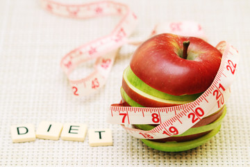 An apple and flexible ruler as a concept of dieting and weight control	