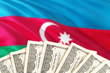 Azerbaijan economy concept. Dollar banknotes on the side of national flag with waving background. Financial theme.
