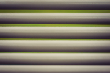 Closeup of White Blind with Green Background