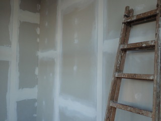  building site with plasterboards and a ladder