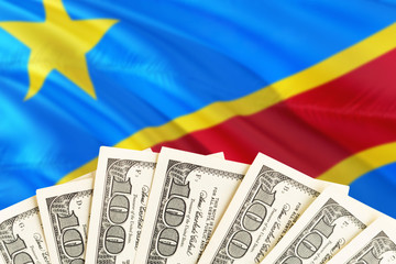 Congo economy concept. Dollar banknotes on the side of national flag with waving background. Financial theme.