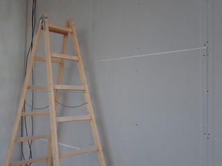  building site with plasterboards and a ladder