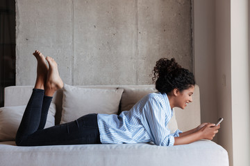 Smiling attractive young african woman wearing shirt relaxing