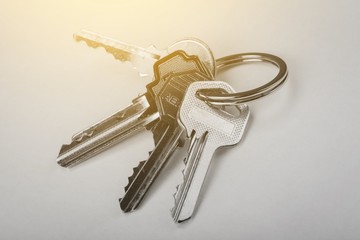 House keys with house figure  on background