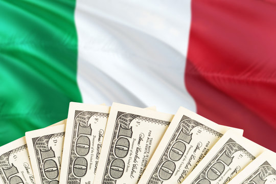 Italy economy concept. Dollar banknotes on the side of national flag with waving background. Financial theme.