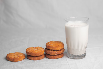 cookies and glass of milk on white background