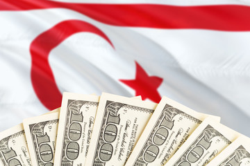 Northern Cyprus economy concept. Dollar banknotes on the side of national flag with waving background. Financial theme.