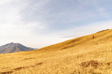 Fototapeta na wymiar Mountain scenery Dolomites with grass and hiker