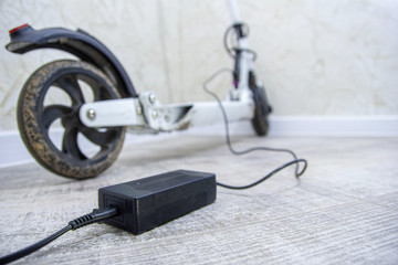 charging the electric scooter battery at home.