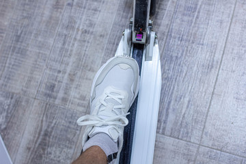 white sneakers on an electric scooter, shoe concept.