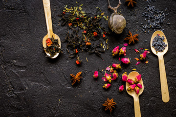 Herbs on spoons black background mock-up top view