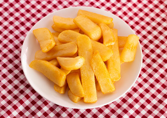 Plate of Chunky Steak Fries on a Red Gingham Table Cloth