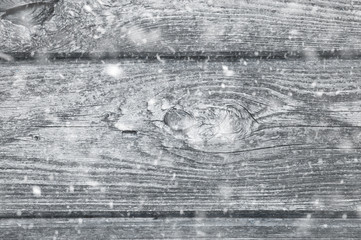 Obraz premium background of old gray wooden boards. falling snow