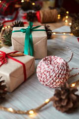 Some christmas presents in decorative boxes on a wooden background