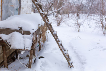 Winter, wooden stairs on the street, covered with snow.