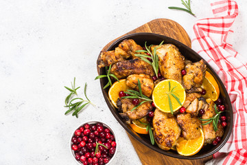 Baked chicken with orange, cranberry and rosemary.