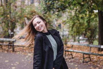 Portrait of stylish smiling happy woman walking in street, positive mood, girl enjoy weekends