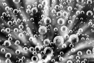 Oxygen Bubbles in Liquid. Rays. Black and white