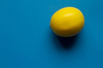 Top view fresh yellow lemon isolate on blue background, background or concept