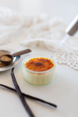 Torching a creme brûlée in white kitchen