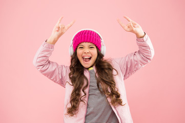 happiness. pink is her favorite color. small kid listen music headset. child long curly hair. haircare in winter season. warm clothes for cold weather. vacation time. happy little girl live pink life