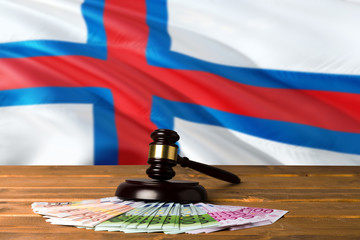 Faroe Islands bribing concept. Law theme, mallet of the judge on wooden desk with national flag...