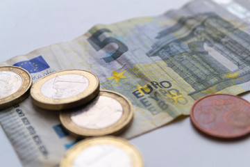 Several euro coins on light blurred background. Closeup photo