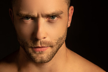 Naklejka premium Handsome sport sexy stripped guy portrait for cosmetics and fitness on isolated black background
